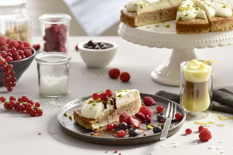 Banana Walnut Barista Cake with chocolate sauce and berries